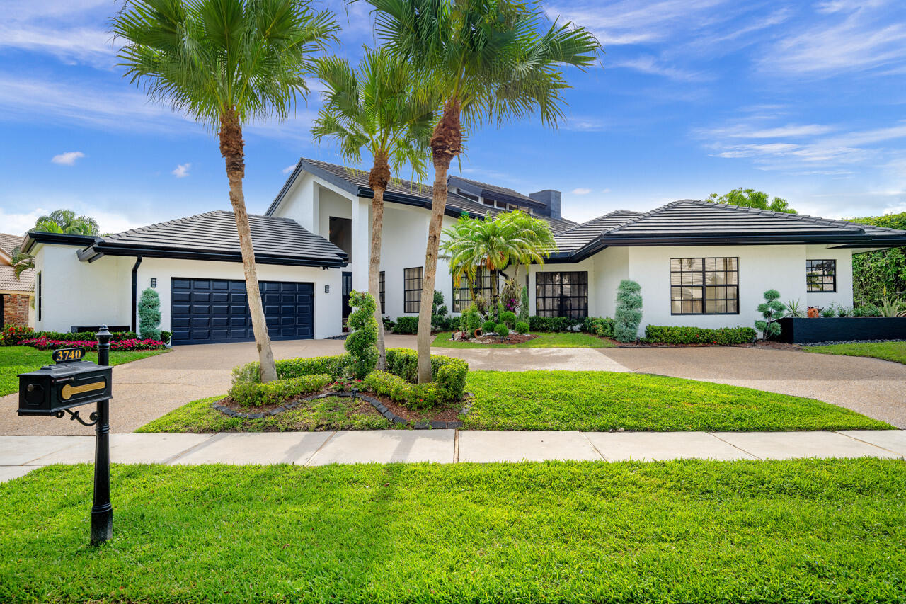 3740 Canterbury Way Boca Raton, FL 33434 - Photo 1 of 55 a front view of a house with a yard and garage