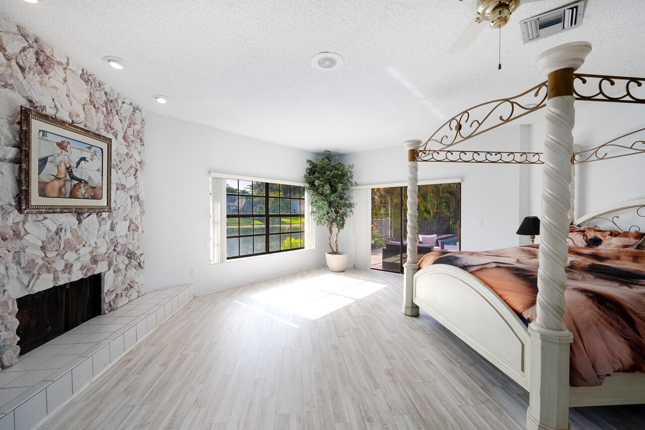 3740 Canterbury Way Boca Raton, FL 33434 - Photo 21 of 55 a bed room with furniture and a fireplace