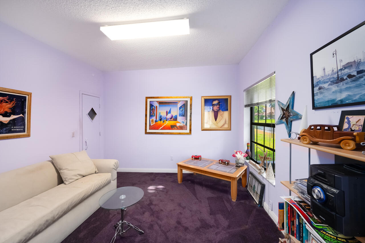 3740 Canterbury Way Boca Raton, FL 33434 - Photo 29 of 55 a living room with furniture and a flat screen tv