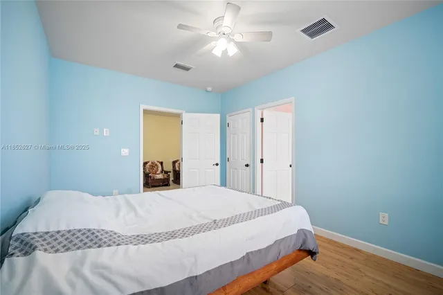 a bedroom with a large bed and a chandelier