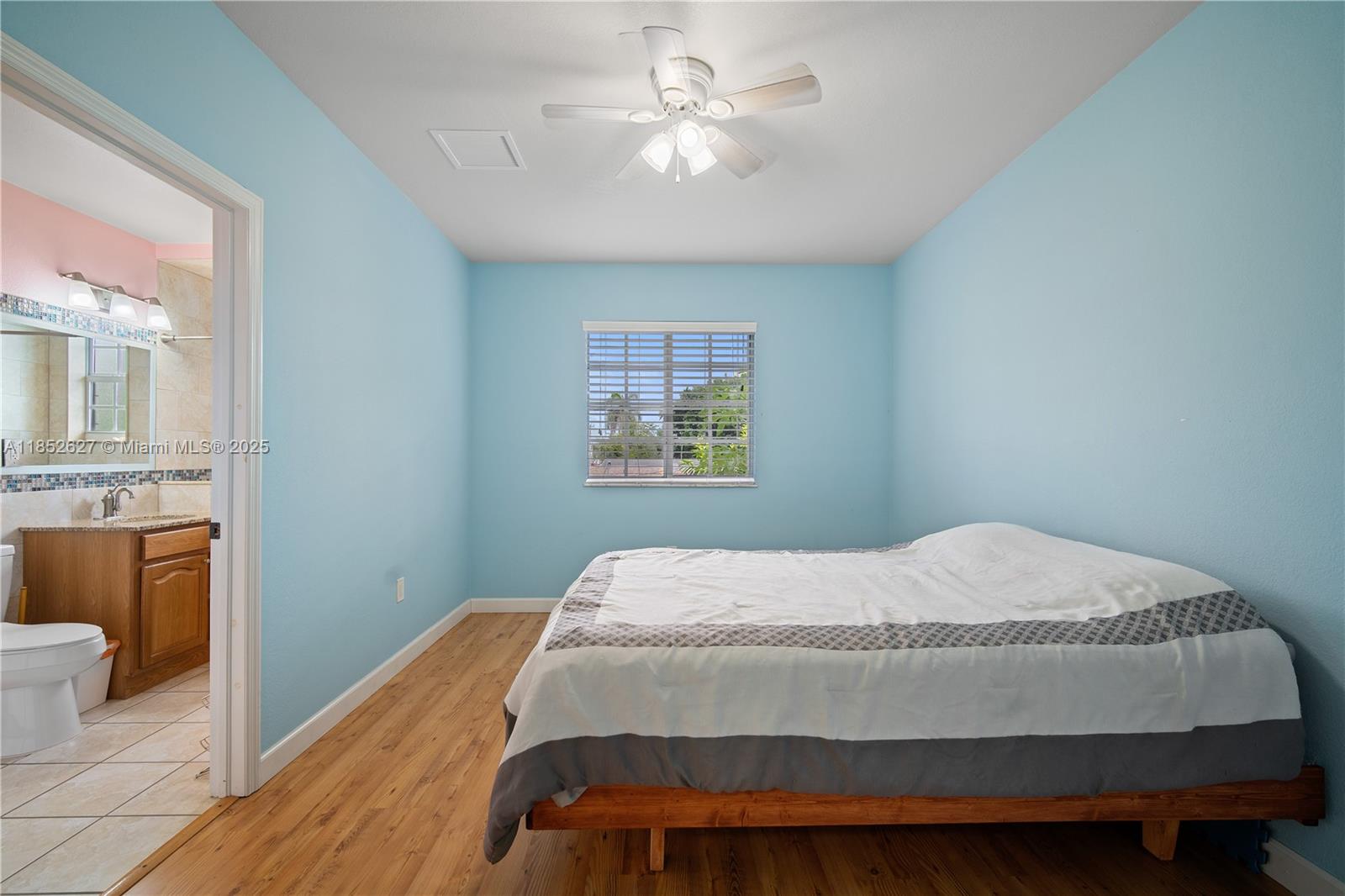 29001 Southwest 157th Avenue Homestead, FL 33033 - Photo 13 of 23 a bedroom with a bed and a chandelier