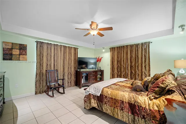 a spacious bedroom with a bed and a chandelier
