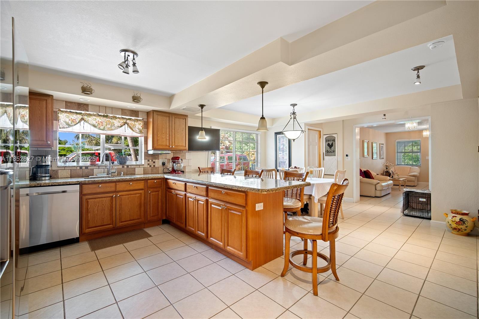 29001 Southwest 157th Avenue Homestead, FL 33033 - Photo 21 of 23 a kitchen with a sink dining table and chairs