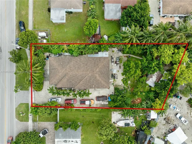 an aerial view of a house with a yard and garden