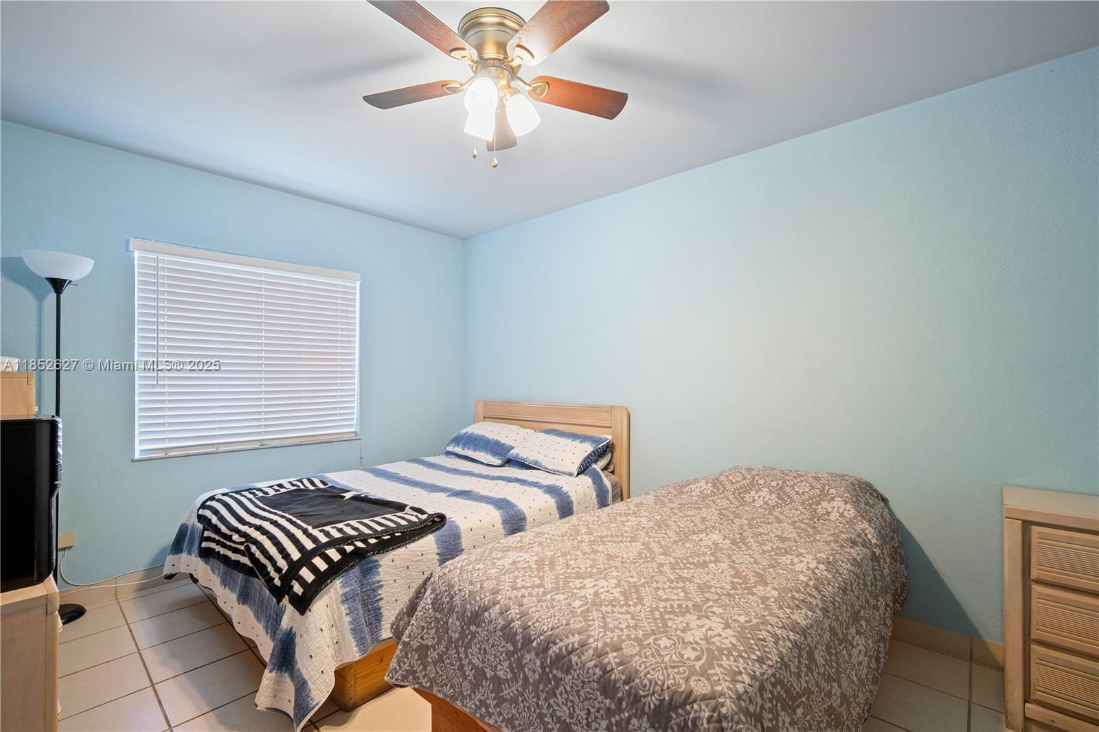 29001 Southwest 157th Avenue Homestead, FL 33033 - Photo 4 of 23 a bedroom with two beds and a chandelier