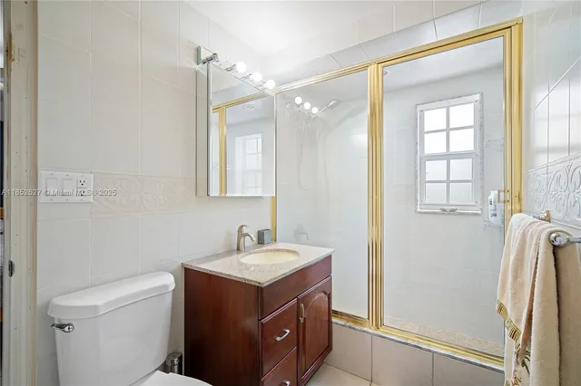 a bathroom with a sink mirror vanity and toilet