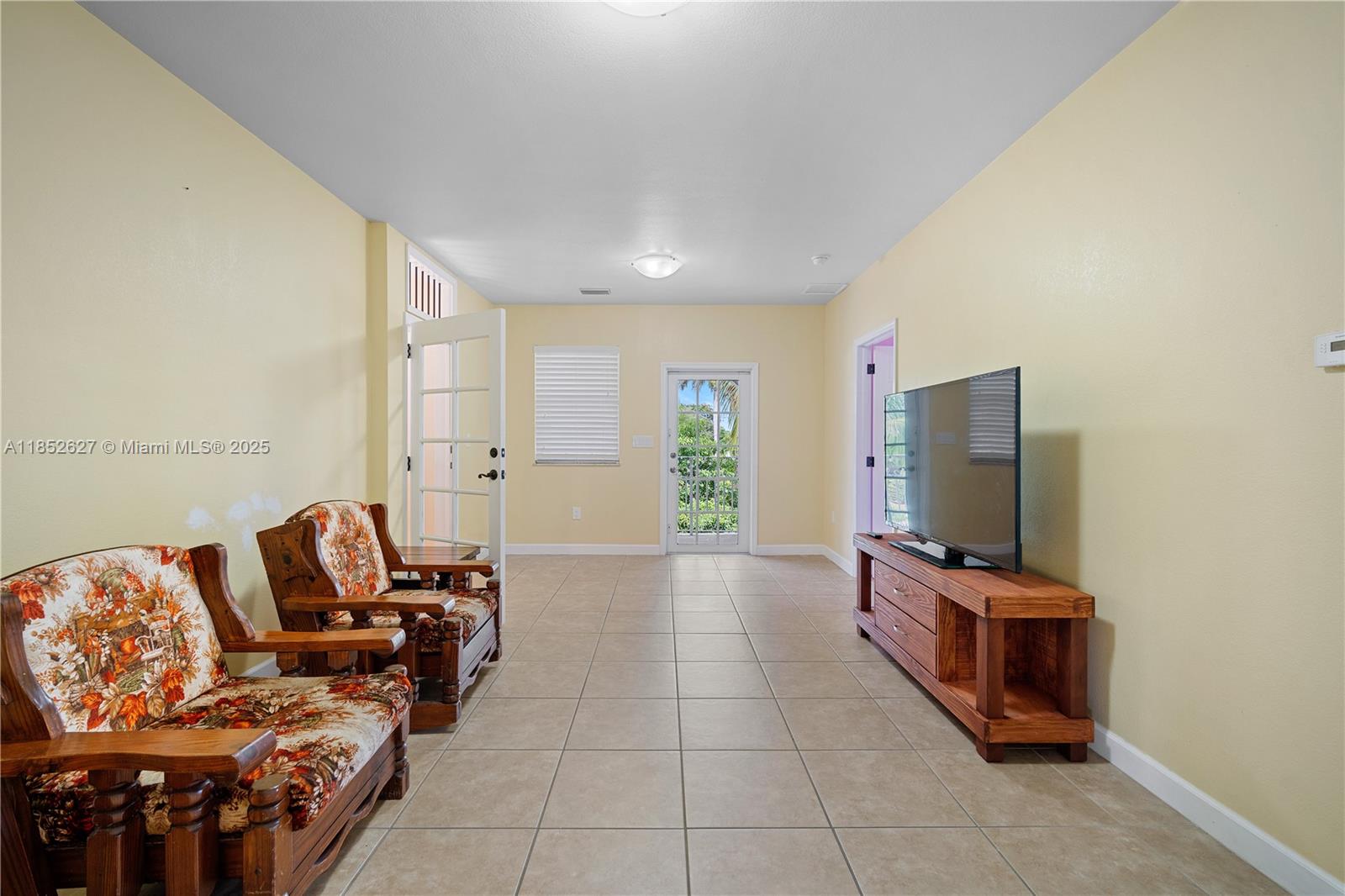 29001 Southwest 157th Avenue Homestead, FL 33033 - Photo 6 of 23 a living room with furniture and a flat screen tv