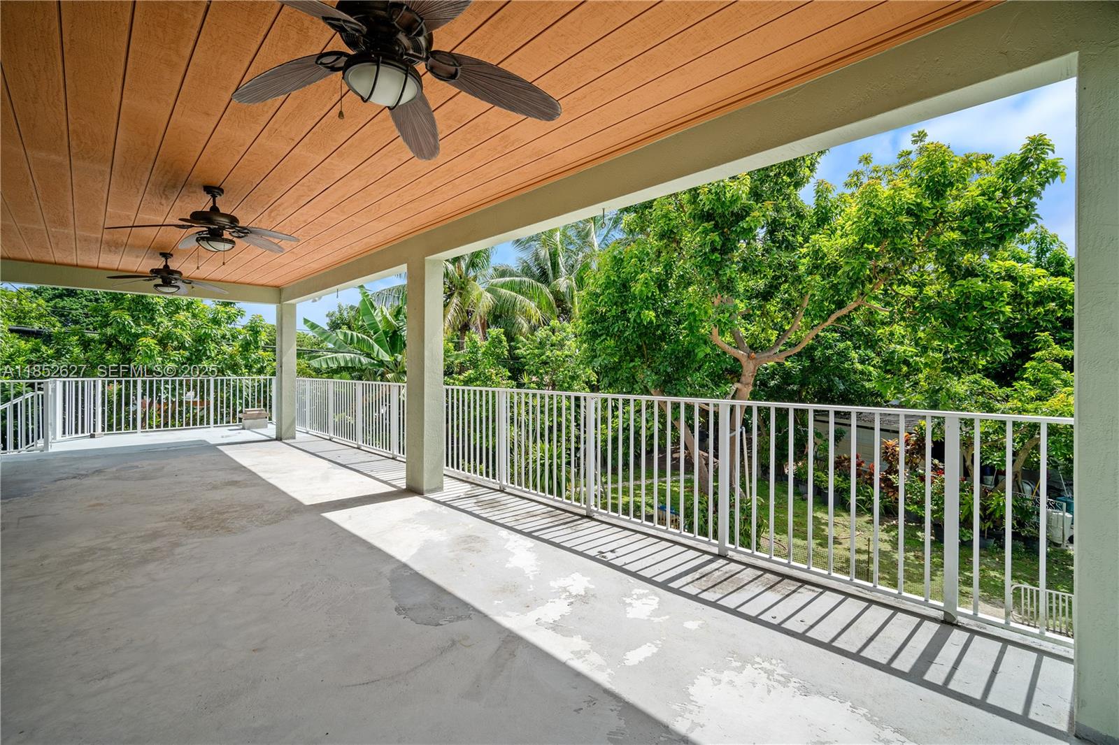 29001 Southwest 157th Avenue Homestead, FL 33033 - Photo 7 of 23 a view of a balcony with a floor to ceiling window and tree