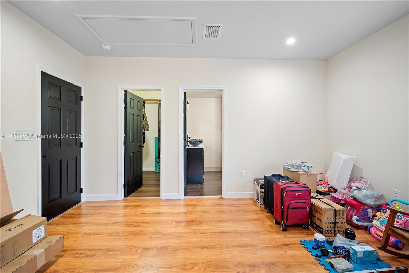 29001 Southwest 157th Avenue Homestead, FL 33033 - Photo 10 of 23 a bedroom with a bed and a chandelier