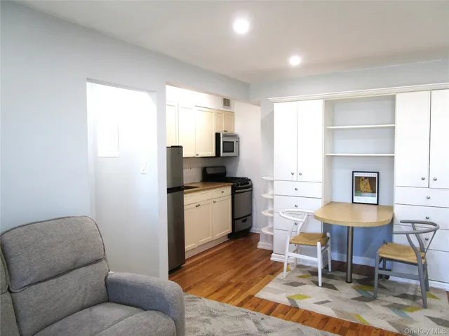 a kitchen with a refrigerator and a stove top oven