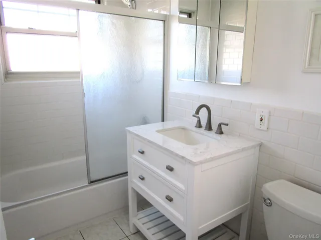 a close view of cabinet a mirror and a window