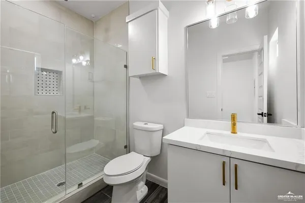 a bathroom with a sink toilet and shower