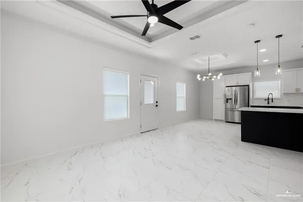 a view of a kitchen with a sink and refrigerator