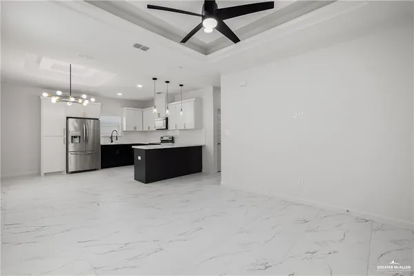 a large kitchen with cabinets and stainless steel appliances