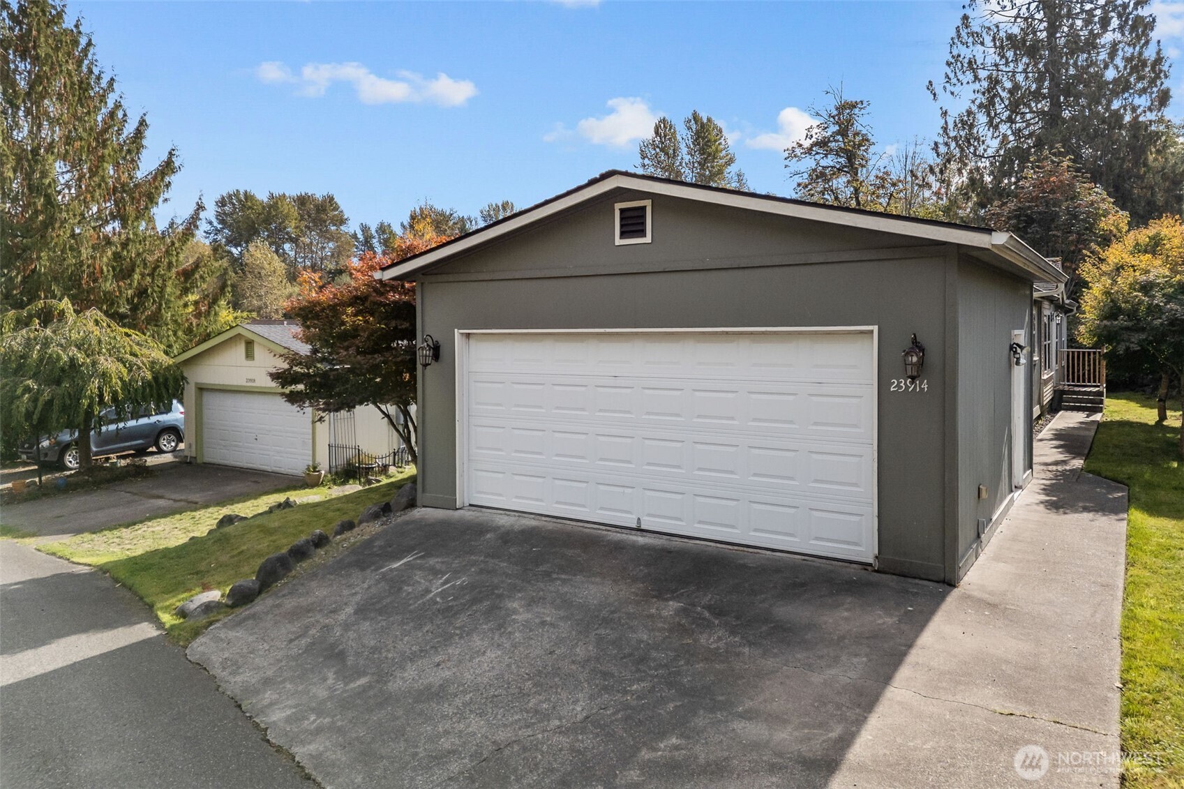 a front view of a house with a yard and garage