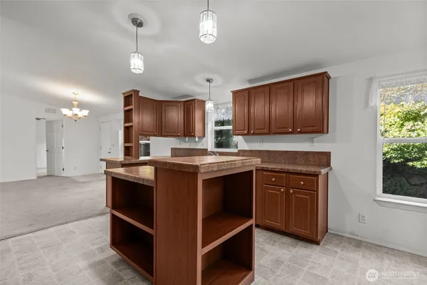 a kitchen with stainless steel appliances granite countertop a stove refrigerator and microwave