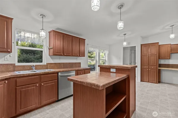 a kitchen with a sink stove and refrigerator