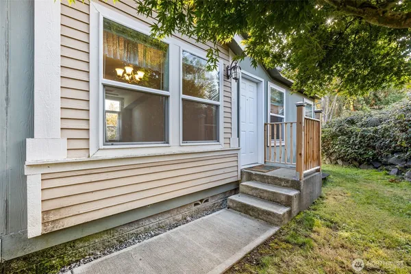 a view of a house with a yard and wooden fence