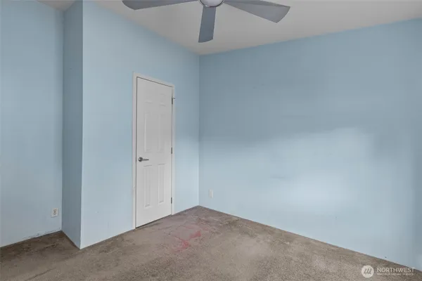 an empty room with a empty space and chandelier fan
