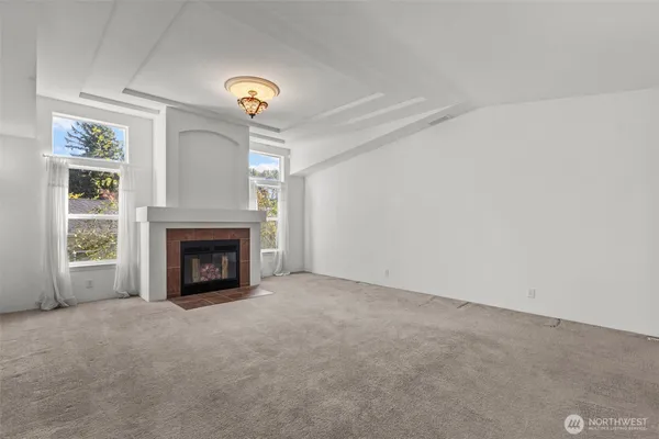 a view of an empty room with a fireplace