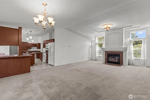 a view of a kitchen with a sink and a fireplace