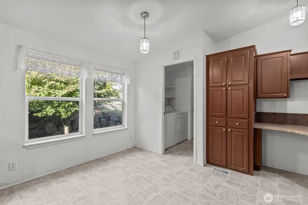a view of a kitchen with refrigerator and cabinet