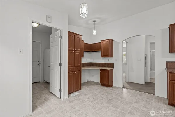a view of a kitchen with a sink and dishwasher a refrigerator a fireplace