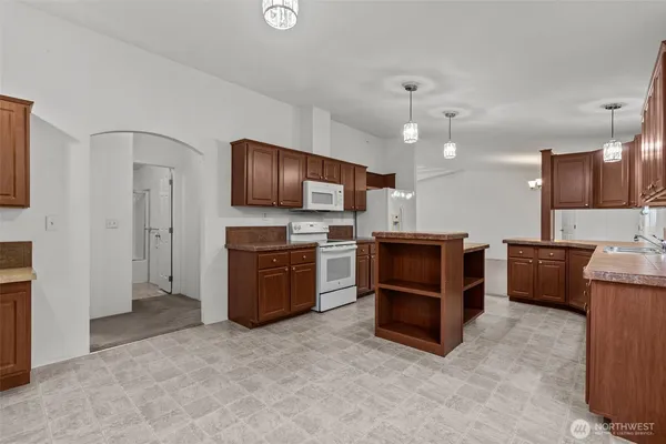 a large kitchen with cabinets and stainless steel appliances