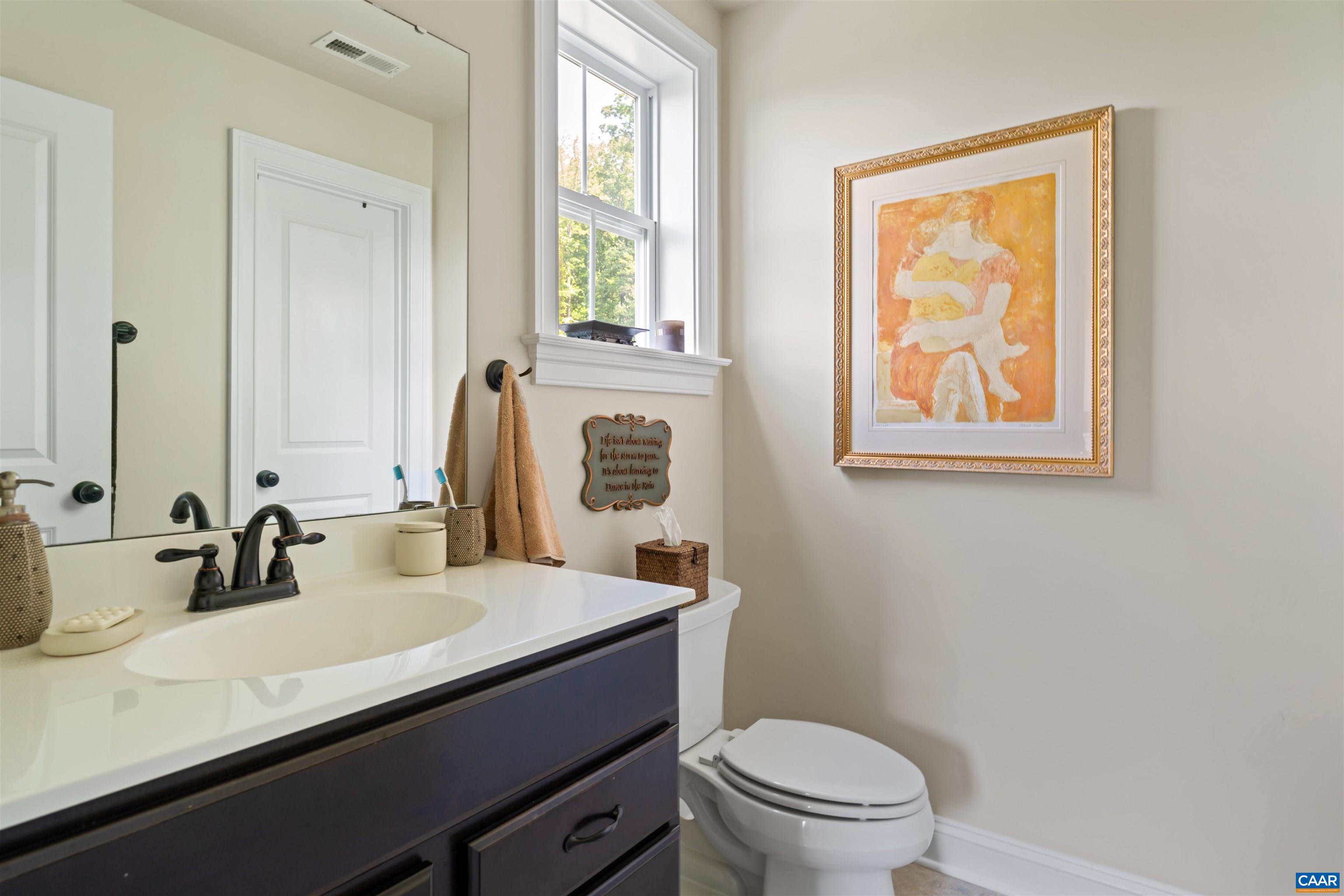 2246 Hyland Ridge Drive Charlottesville, VA 22911 - Photo 29 of 53 a bathroom with a sink a toilet and a mirror
