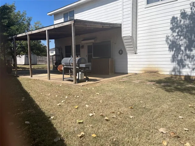 a view of a house with backyard porch and sitting area