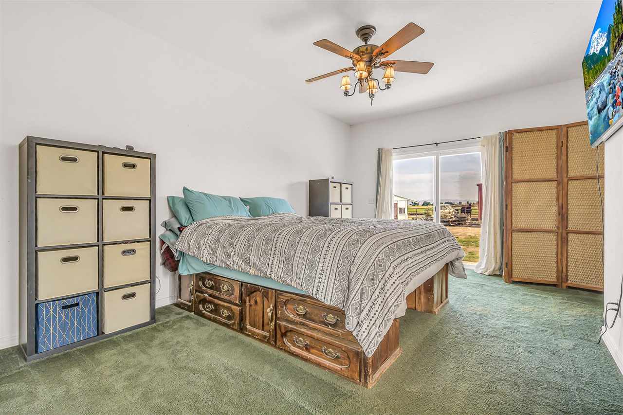 1356 Saddle Ridge Road Loma, CO 81524 - Photo 18 of 37 a spacious bedroom with a bed and a cabinets