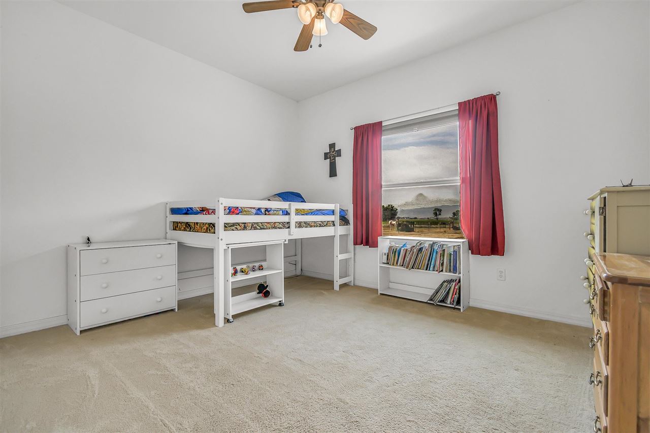 1356 Saddle Ridge Road Loma, CO 81524 - Photo 21 of 37 a view of a bedroom with furniture and a window
