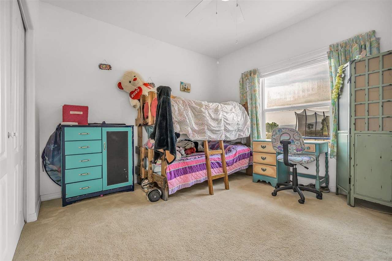 1356 Saddle Ridge Road Loma, CO 81524 - Photo 22 of 37 a bedroom with furniture and a bed