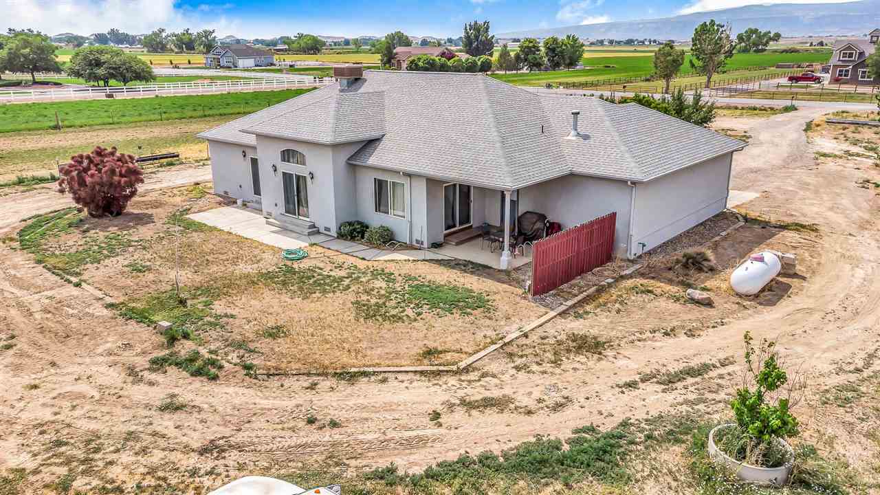 1356 Saddle Ridge Road Loma, CO 81524 - Photo 30 of 37 an aerial view of a house with a yard and lake view