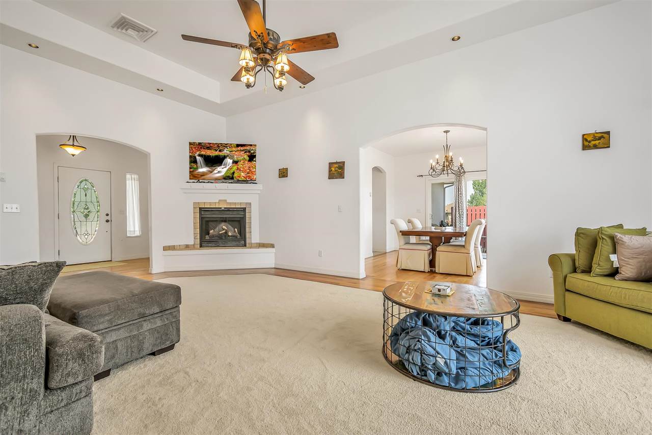 1356 Saddle Ridge Road Loma, CO 81524 - Photo 7 of 37 a living room with furniture a fireplace and a chandelier