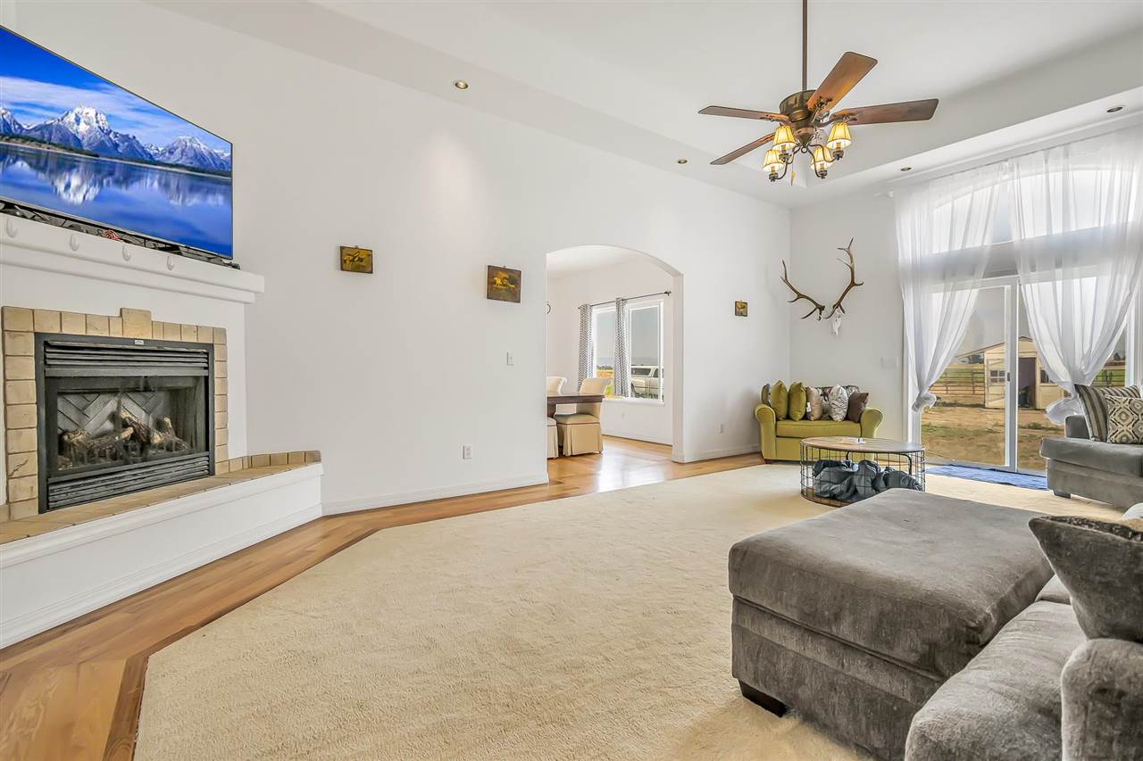 1356 Saddle Ridge Road Loma, CO 81524 - Photo 8 of 37 a bedroom with furniture and a fireplace