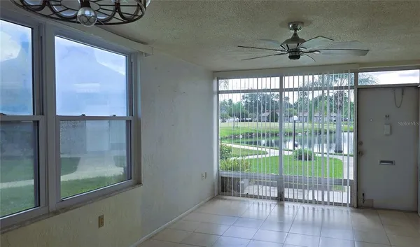 a view of a livingroom with a ceiling fan and window