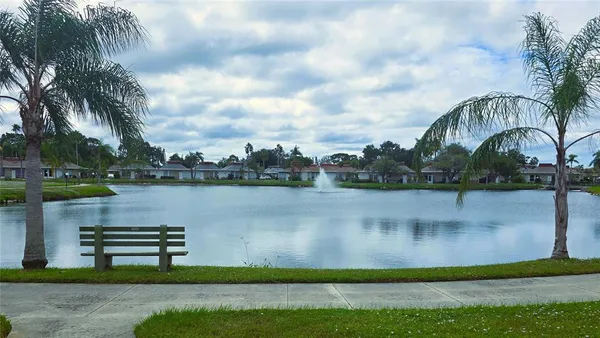 a view of a lake with houses in the background