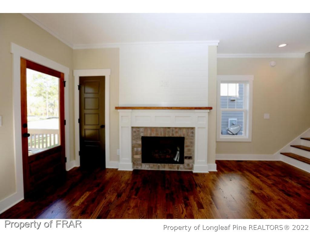 229 Springwood Way Southern Pines, NC 28387 - Photo 2 of 4 a view of an empty room with wooden floor and a window