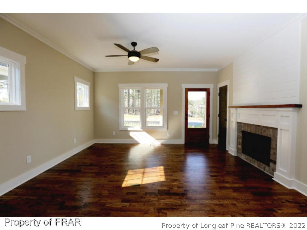 229 Springwood Way Southern Pines, NC 28387 - Photo 3 of 4 a view of an empty room with wooden floor and a window