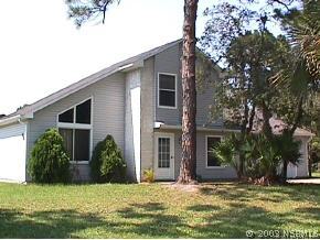 2231 Yule Tree Drive Edgewater, FL 32141 - Photo 1 of 1 a view of a house with yard and plants