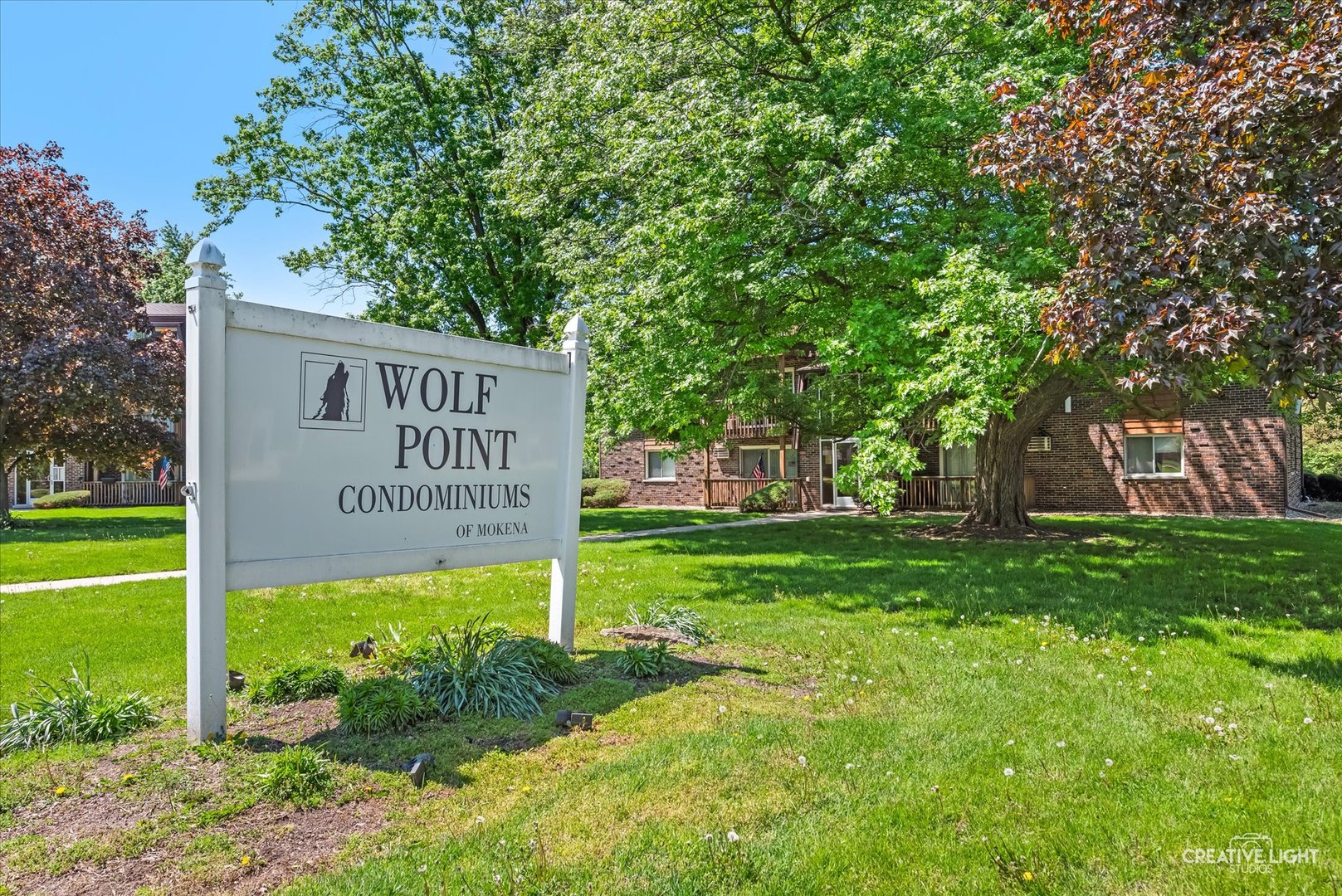 19360 Wolf Road, Unit 9 Mokena, IL 60448 - Photo 2 of 16 a sign on the side of the tree