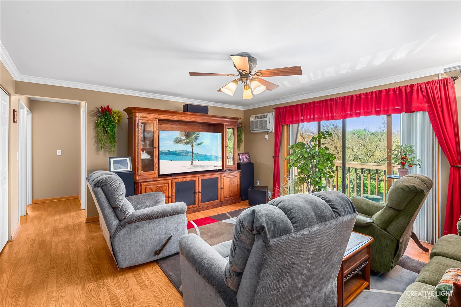 19360 Wolf Road, Unit 9 Mokena, IL 60448 - Photo 3 of 16 a living room with furniture a flat screen tv and a large window