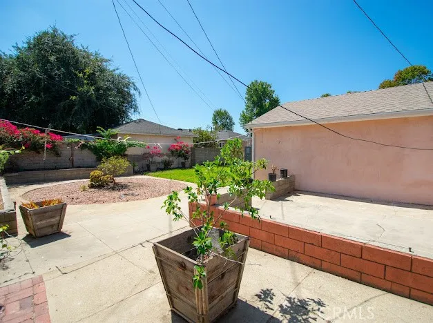a view of a patio with couches and potted plants