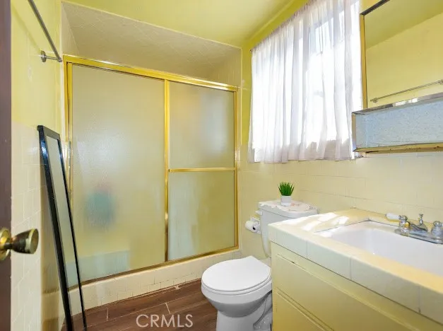 a bathroom with a sink a toilet and a shower