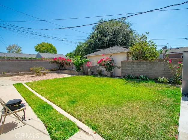 a view of a backyard with plants and a patio