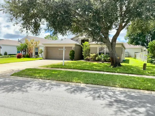 a front view of house with yard and green space