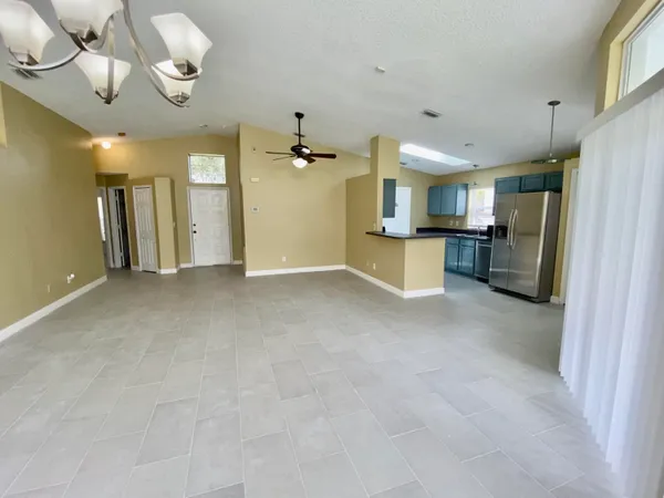a view of a kitchen with a sink and refrigerator