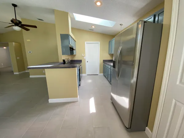 a kitchen with refrigerator and tub