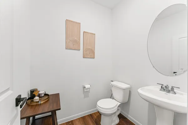 a bathroom with a sink a toilet and mirror